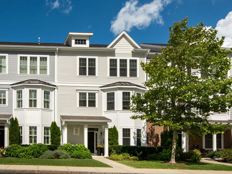 Row of attached townhomes along a residential street